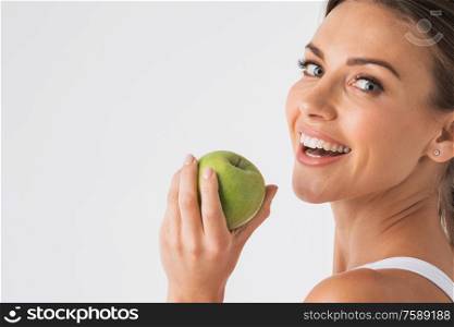 Young beauty woman with green apple on white background. Woman with green apple