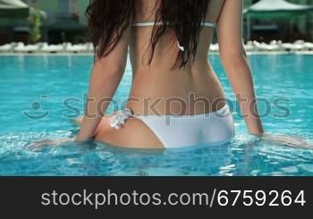 Young Bikini Woman in Swimming Pool, Rear View