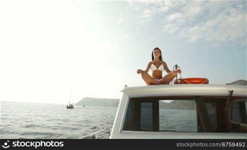 Young Bikini Woman Relaxing on Luxury Yacht