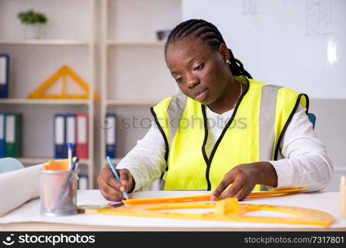 Young black architect working on project 