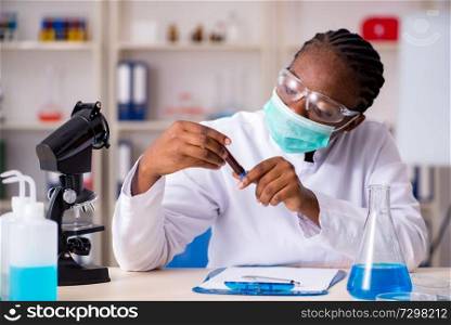 Young black chemist working in the lab 