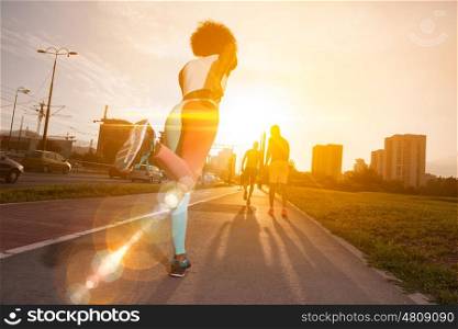 young black girl on the jogging beautiful morning as the sun rises in the streets of the city