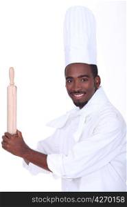 young black male cook is taking a rolling pin like a base-ball player