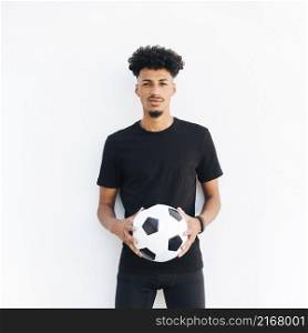 young black man with ball looking camera