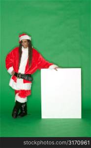 Young Black Santa Standing Next to Blank Sign