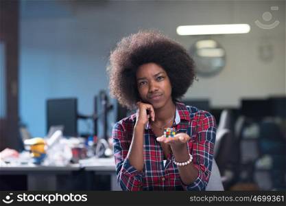 young black woman at her workplace in modern office relaxing and working on laptop computer