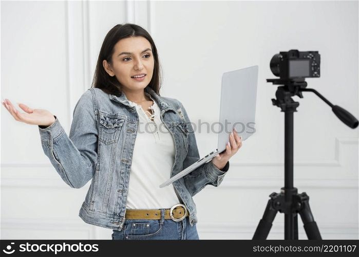 young blogger holding laptop