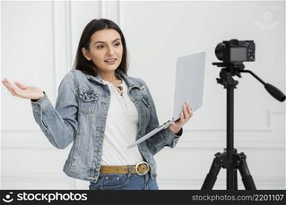 young blogger holding laptop