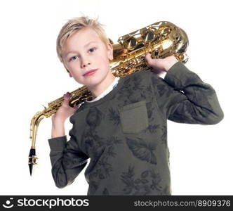 young blond boy and saxophone in studio against white background