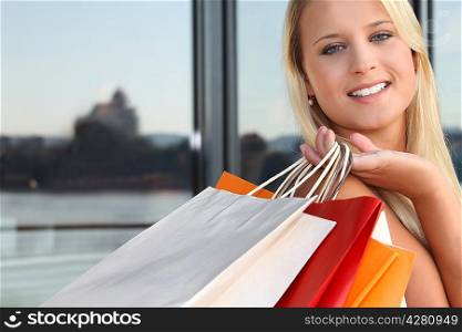 Young blond carrying shopping bags