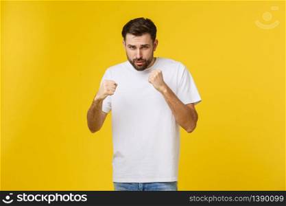 Young blond curly hair caucasian man isolated throwing a punch, anger, fighting due to an argument, boxing.. Young blond curly hair caucasian man isolated throwing a punch, anger, fighting due to an argument, boxing