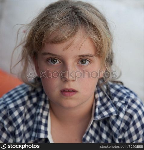 Young blond girl looking at the camera