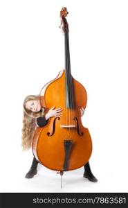 young blond girl looks from behind double bass in studio against white background