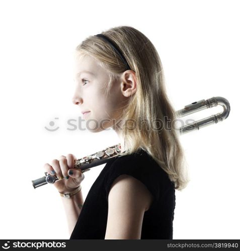 young blond girl sits holding flute on shoulder in studio against white background