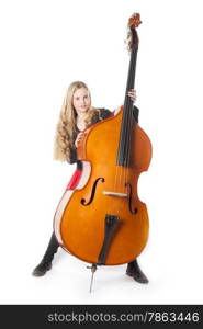 young blond girl stands behind double bass in studio against white background