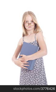 young blond girl with glasses and large book in studio against white background