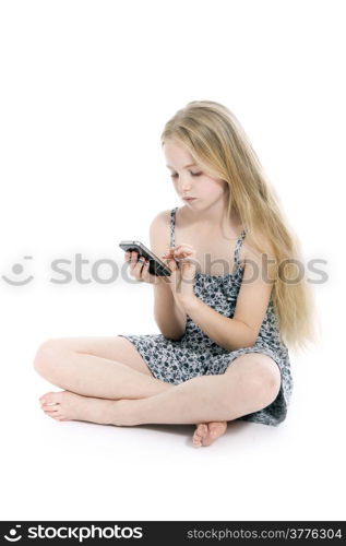 young blond girl with mobile phone in studio against white background