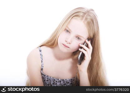 young blond girl with mobile phone in studio against white background