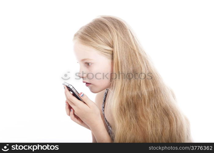 young blond girl with mobile phone in studio against white background