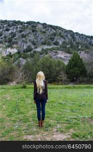 Young blond woman alone in nature