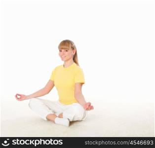young blond woman doing yoga exercise indoors