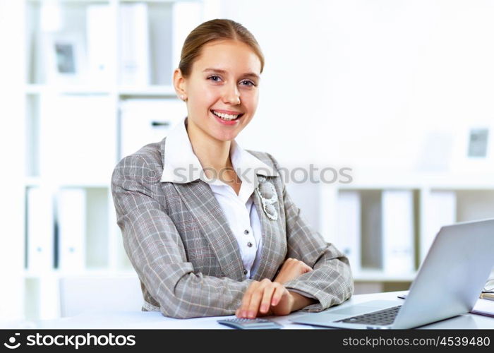 Young blond woman in business wear in office environment