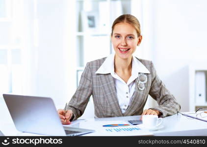 Young blond woman in business wear in office environment