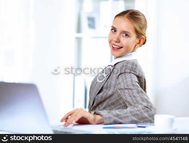 Young blond woman in business wear in office environment