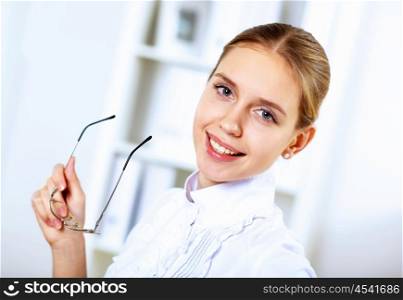 Young blond woman in business wear in office environment