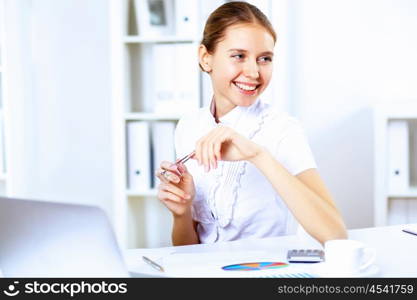 Young blond woman in business wear in office environment