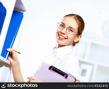 Young blond woman in business wear in office environment