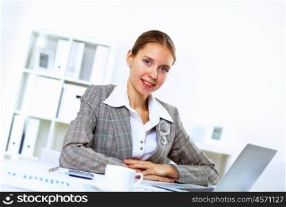 Young blond woman in business wear in office environment