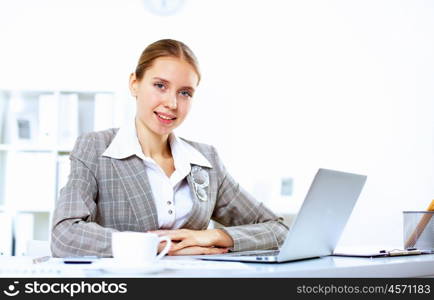 Young blond woman in business wear in office environment