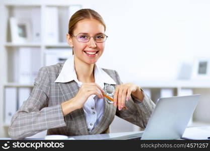 Young blond woman in business wear in office environment