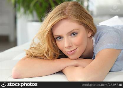 Young blond woman laying on her front