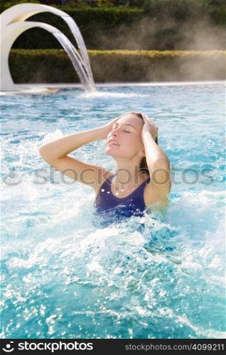 young blond woman relaxing in beauty spa