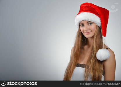 young blond woman with santa red hat looking in camera