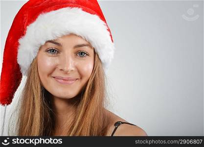 young blond woman with santa red hat looking in camera