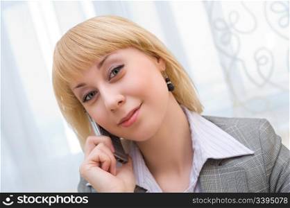 young blonde businesswoman speaks over cell phone
