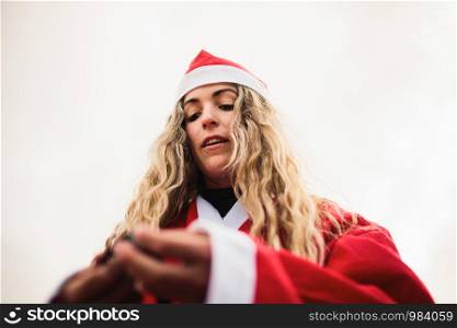 Young blonde dresses up Santa Claus on the beach
