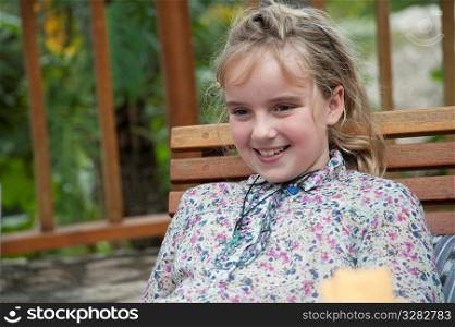 Young blonde girl smiling at the camera