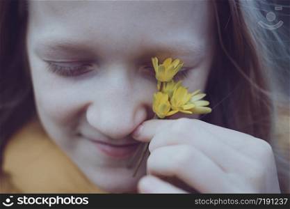 young blonde girl with yellow flowers