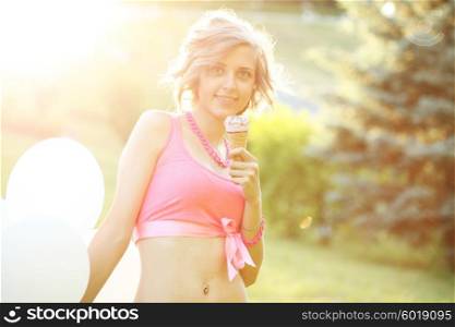 Young blonde hipster girl eating a delicious ice cream in summer hot weather have fun and good mood. Filtered instagram styled photo.