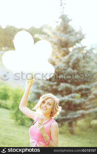 Young blonde hipster girl eating a delicious ice cream in summer hot weather have fun and good mood. Filtered instagram styled photo.