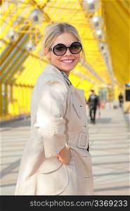 young blonde in sunglasses smiles