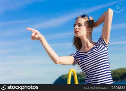 Young blonde woman casual style pointing with finger on sky background
