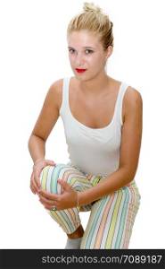 young blonde woman has knee pain isolated on white background