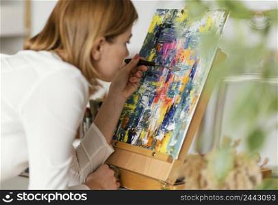 young blonde woman painting with acrylics 2