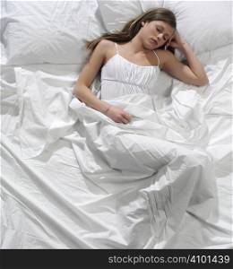 Young blonde woman sleeping in the bed
