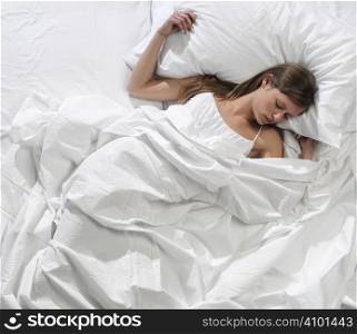 Young blonde woman sleeping in the bed